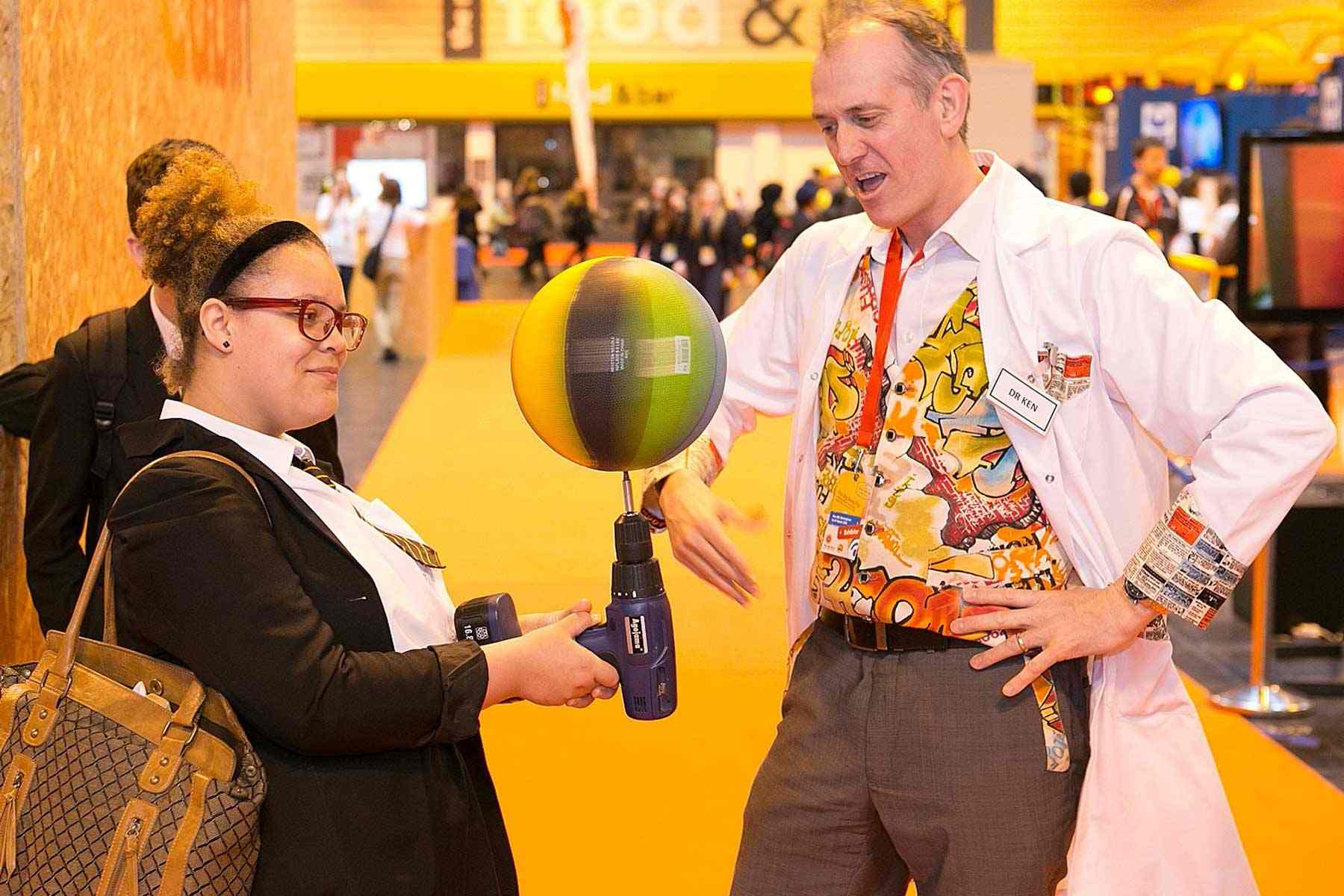 Student balances a spinning basket ball on a rotating drill.