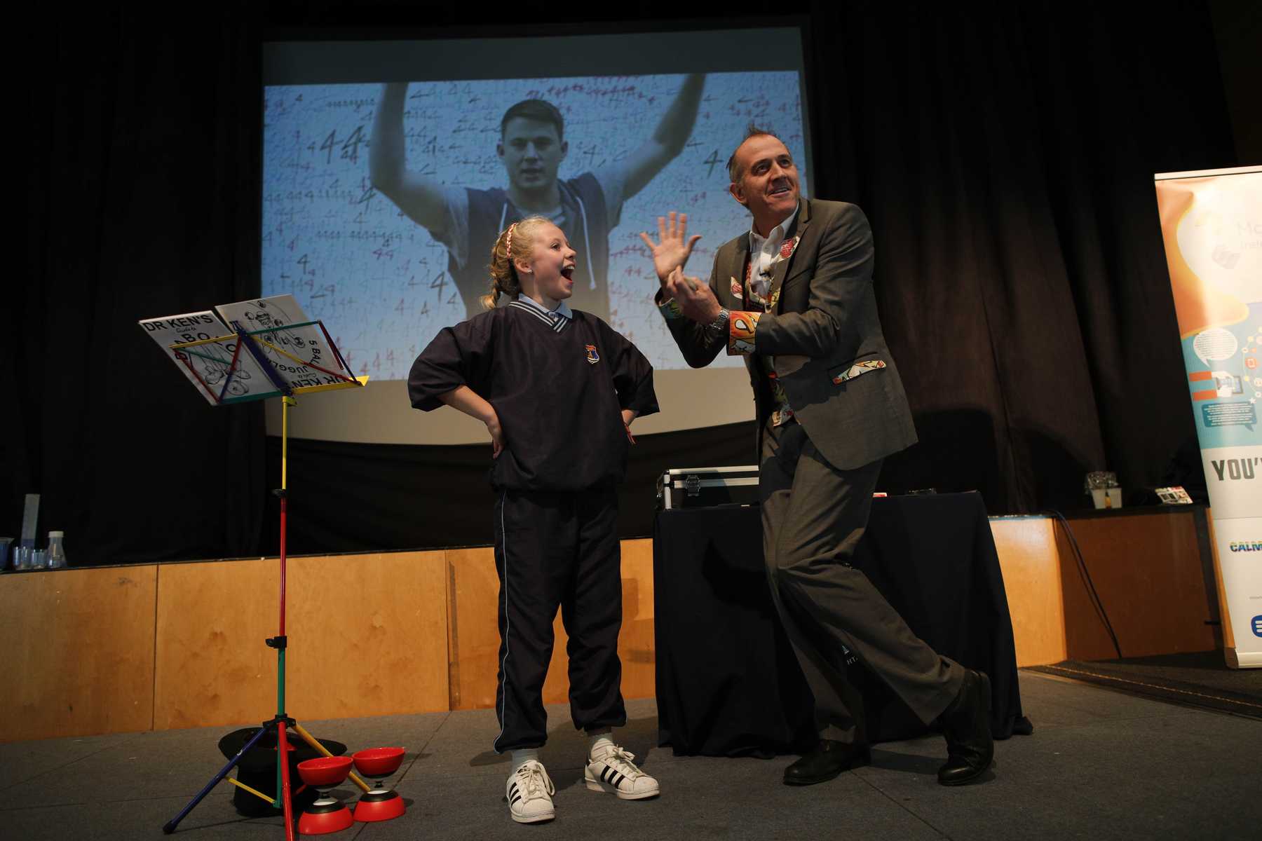 Pupil reaction to a Maths Card Trick Smiling pupil volunteer shows surprise during a maths card trick.
