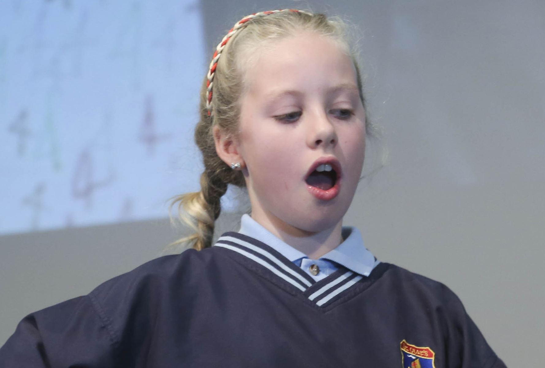 Young pupil reacts in surprise to a maths card trick.