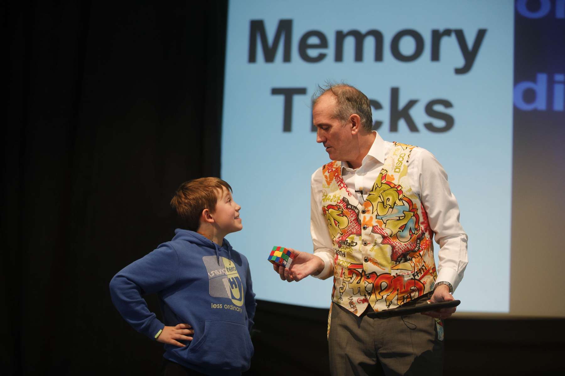 Volunteer challenges Dr Ken to solve the Rubik's cube the fastest.
