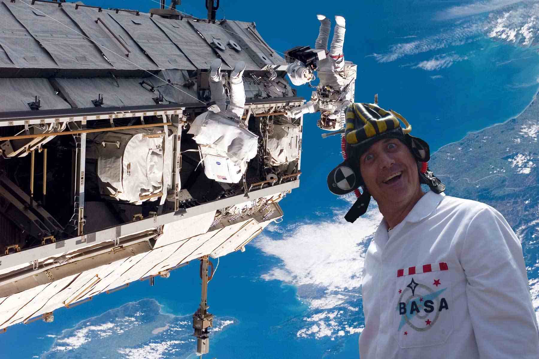 Dr Ken dressed as a BASA scientist - strange lab coat and hat - pictured by the International Space Station.